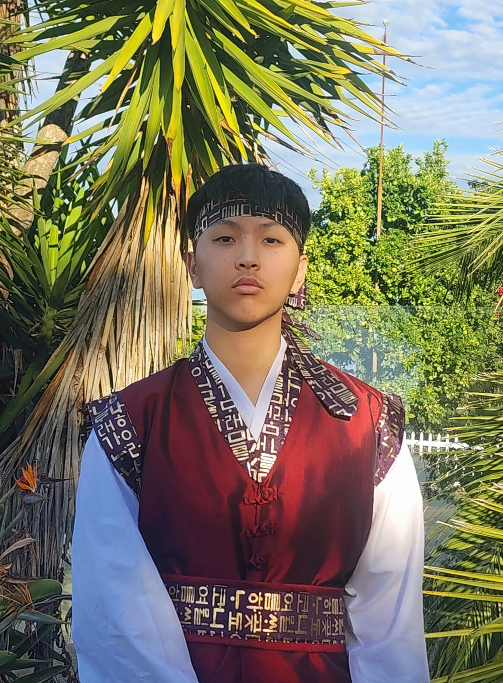 Jaden Kim wearing a traditional Korean performance uniform outdoors