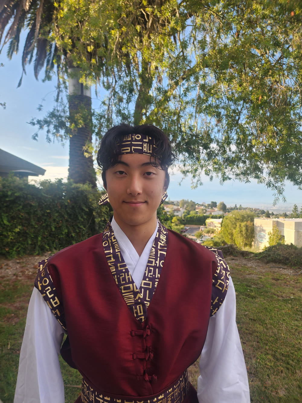 Jason Kim wearing a traditional Korean performance uniform outdoors